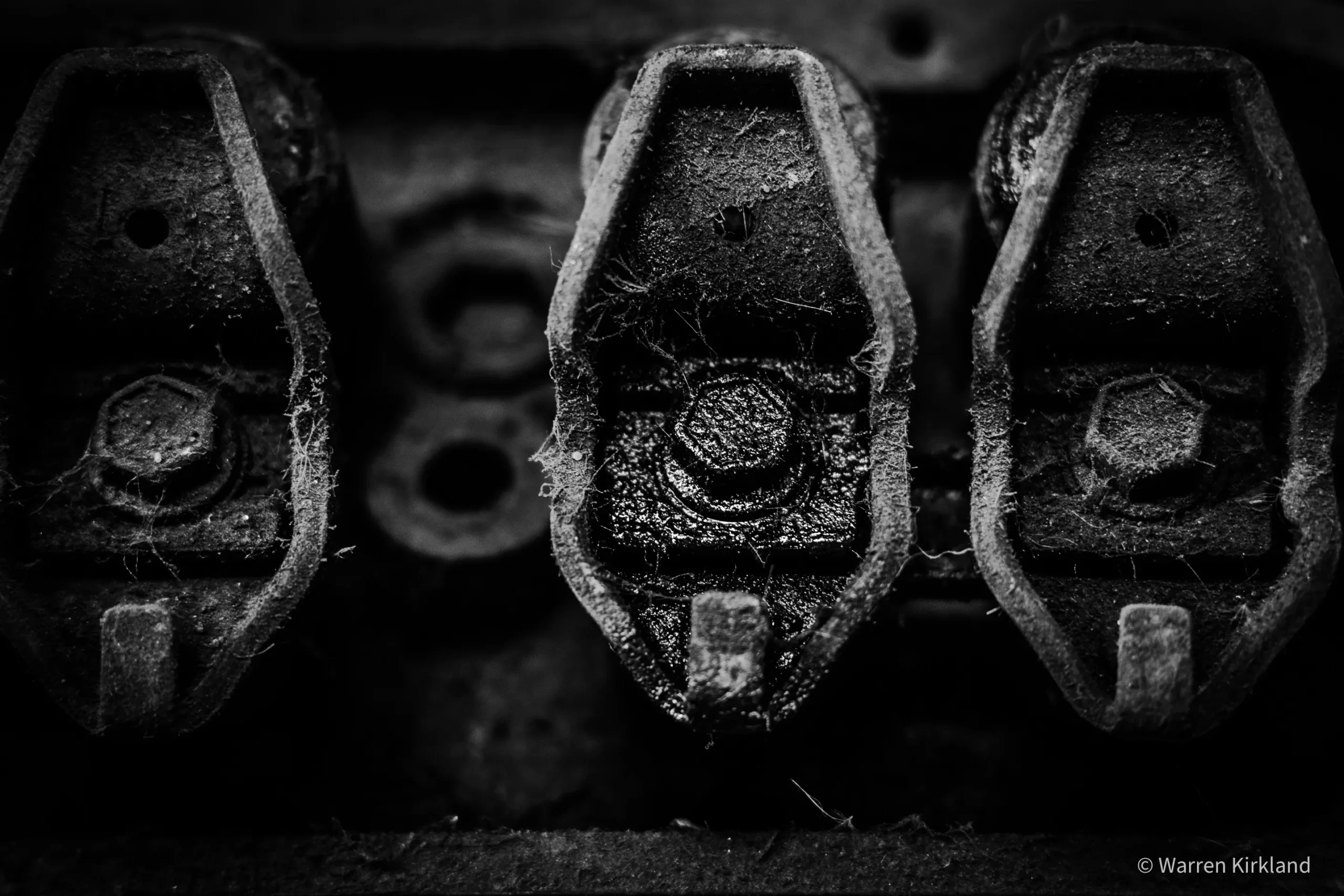 Close-up detail of rusted metal machinery, black and white