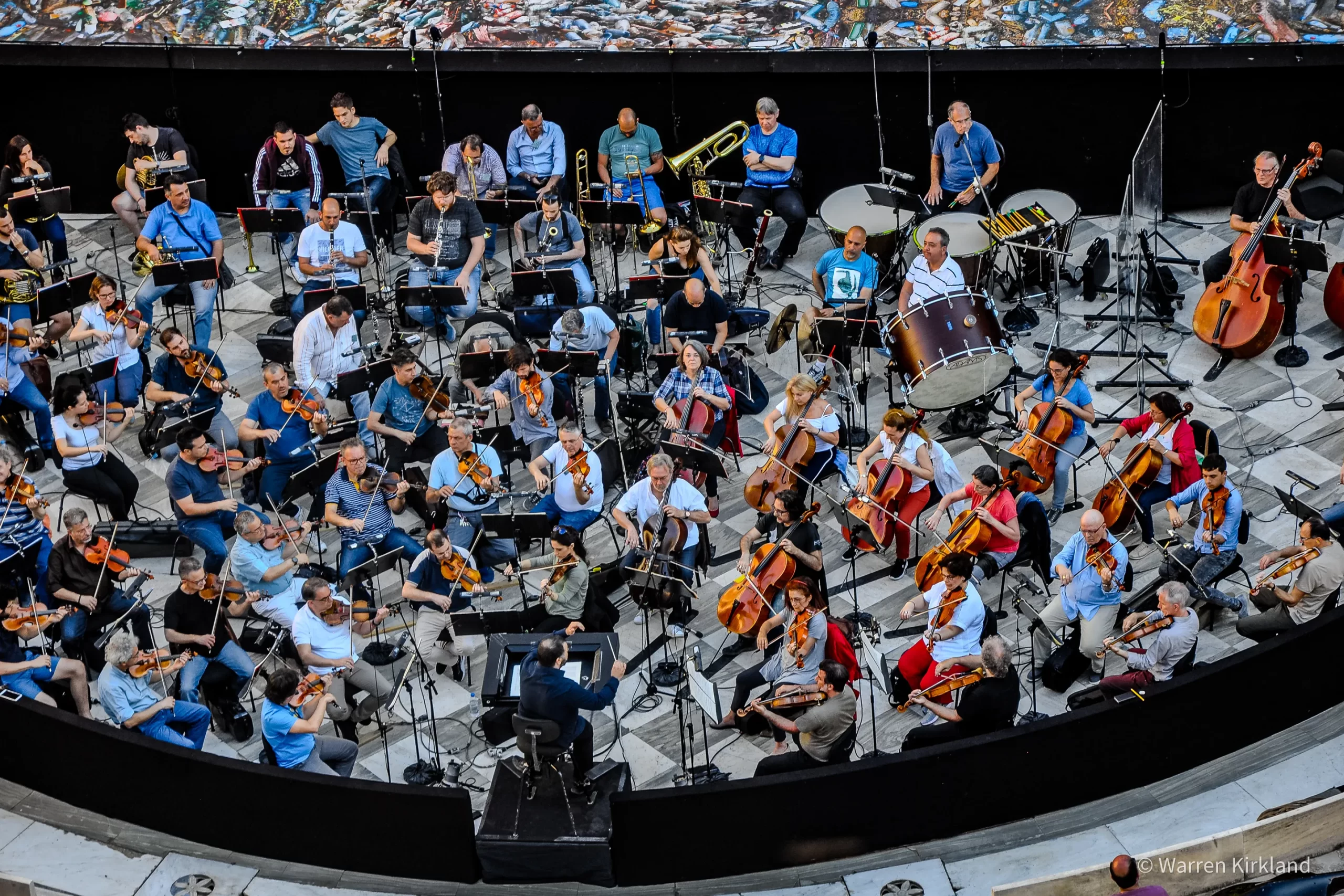 Aerial view of a full orchestra performing in the round