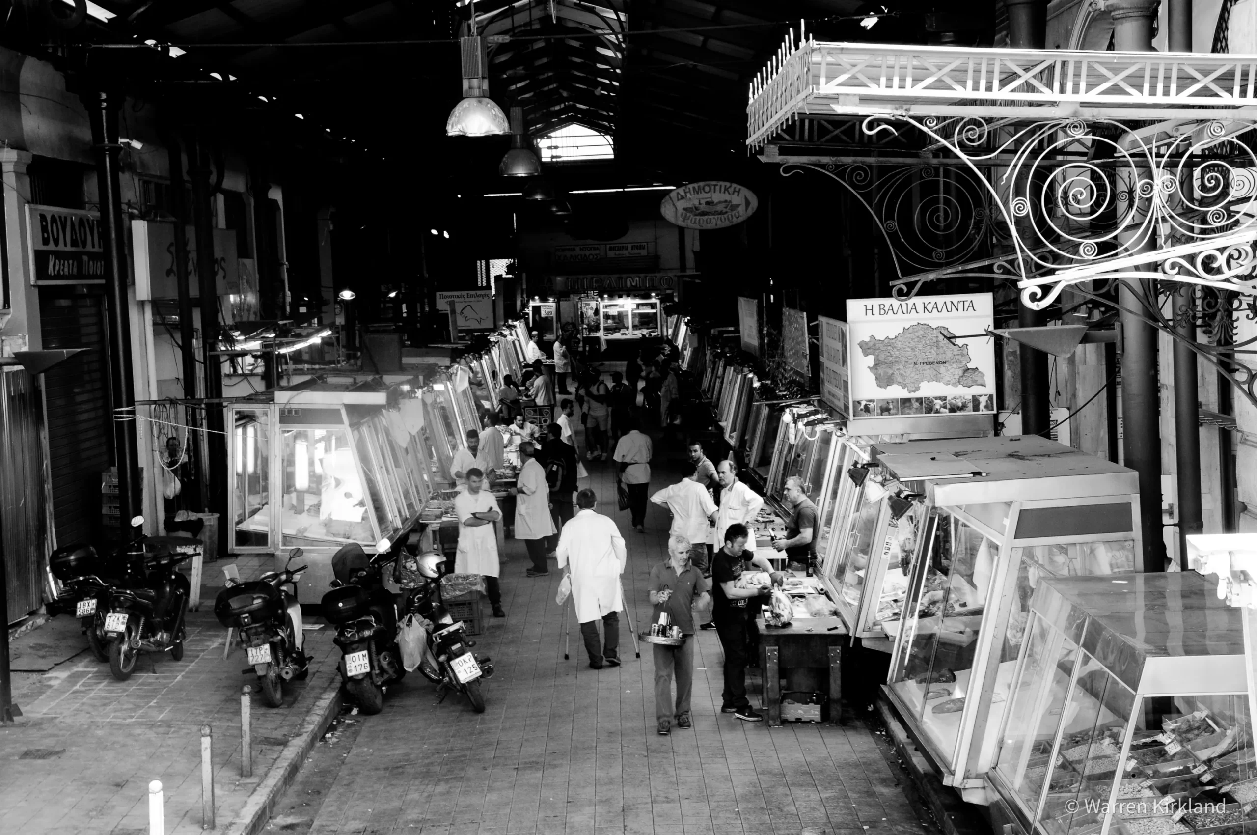 Black and white street scene of a covered market, Greece