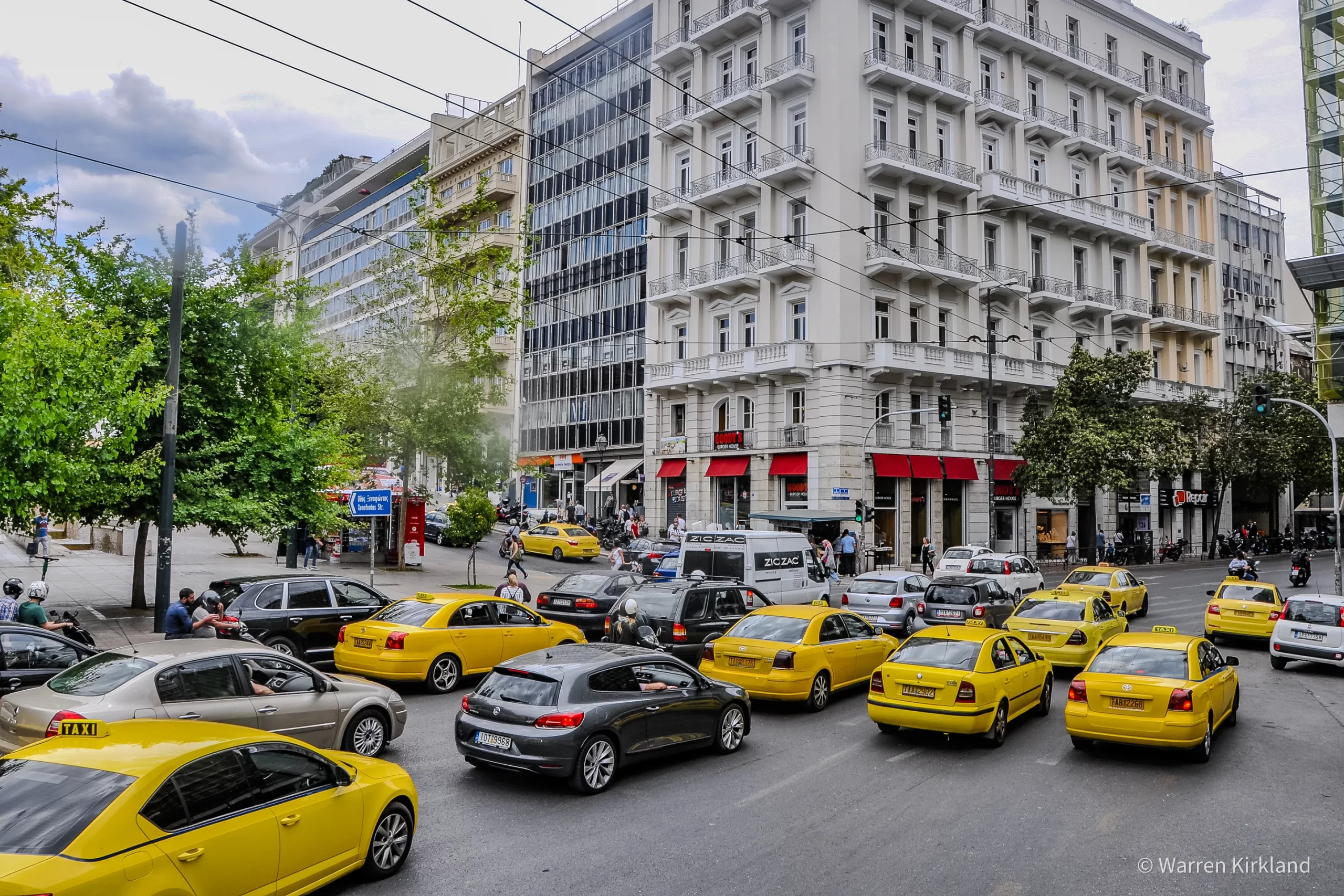 Yellow taxis lined up on a city street, Athens, Greece