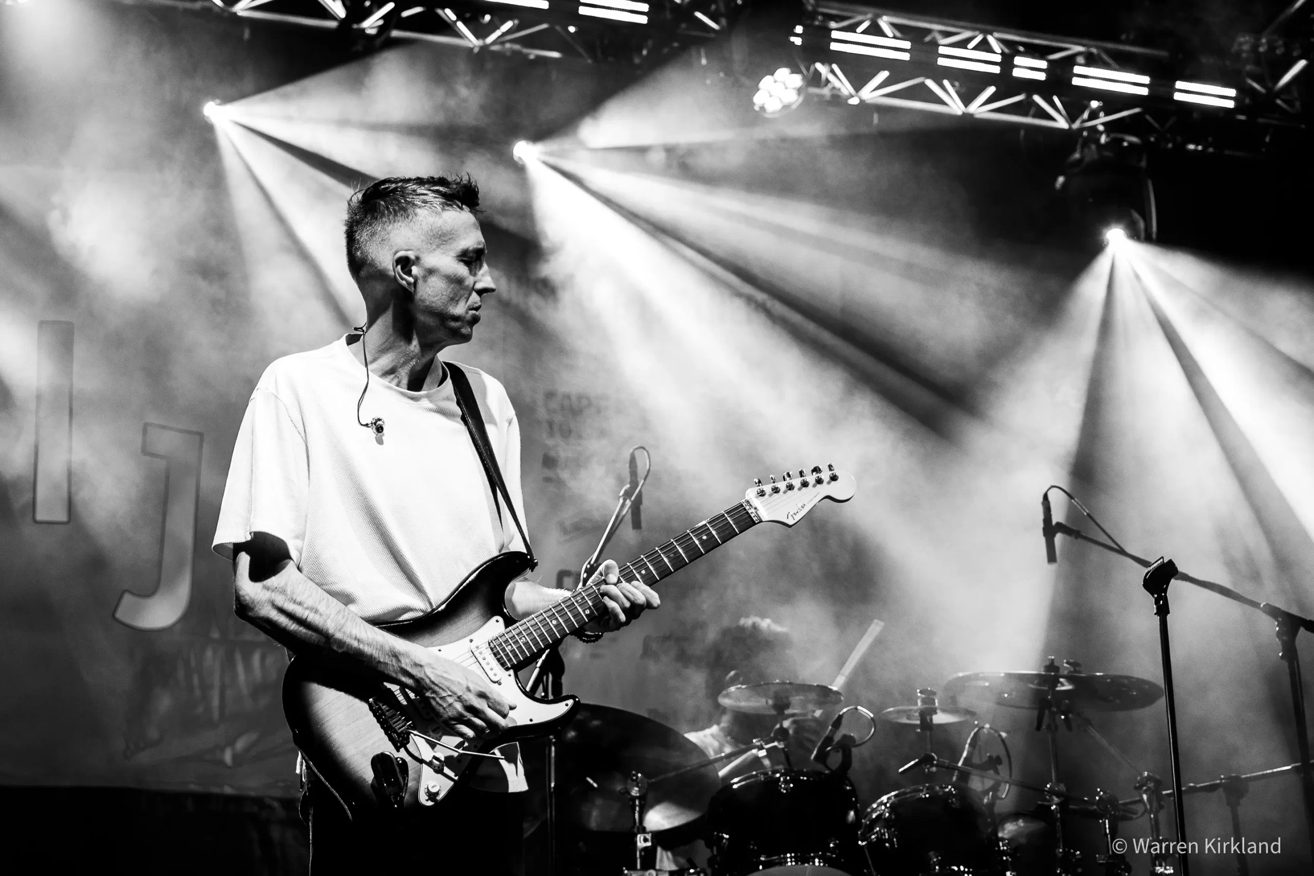 Raymond Green playing guitar with Zoë Modiga's band, black and white