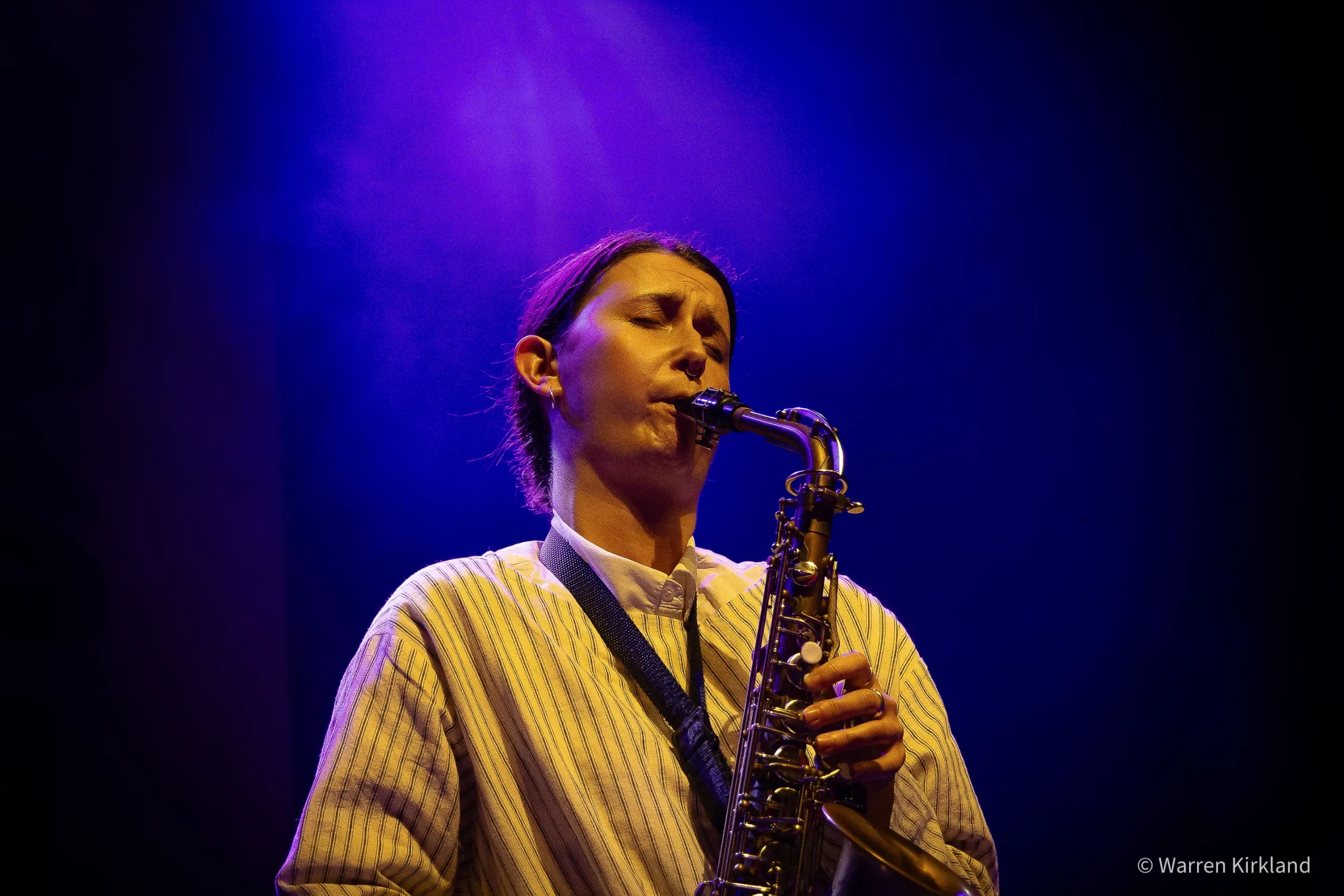 Concert photographer Cape Town capturing Jasmine Myra playing saxophone under a purple light