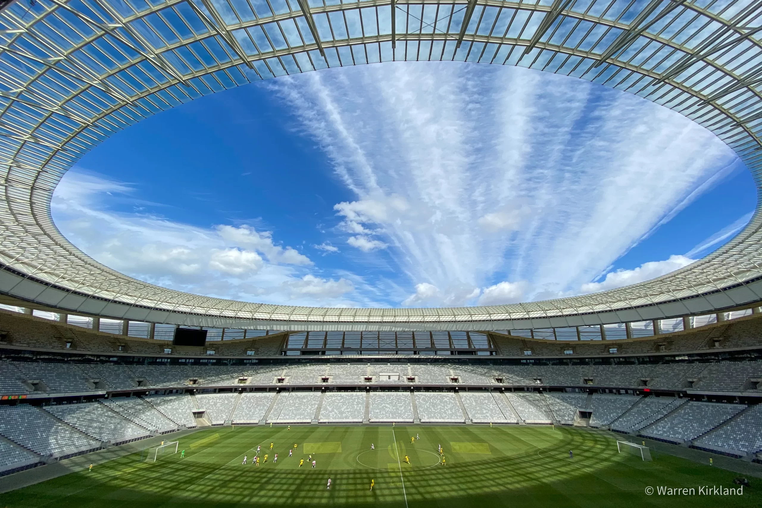Wide interior view of Cape Town Stadium's open roof and pitch below