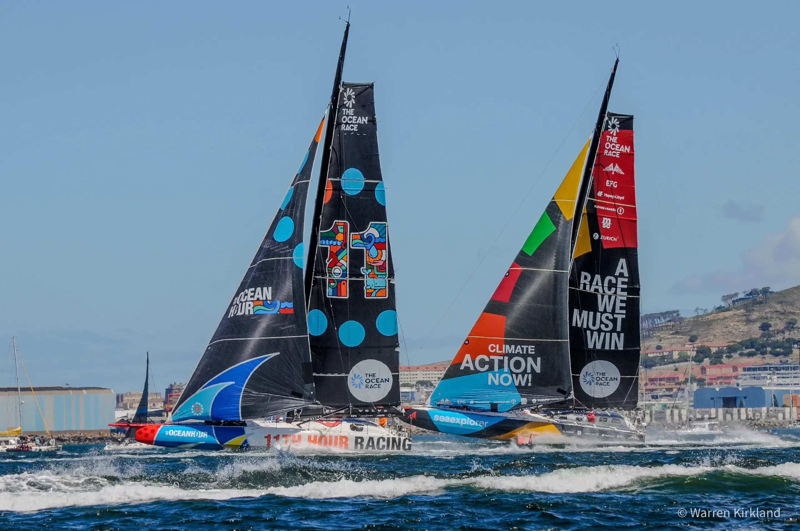 Fleet of Ocean Race yachts sailing close together near Cape Town