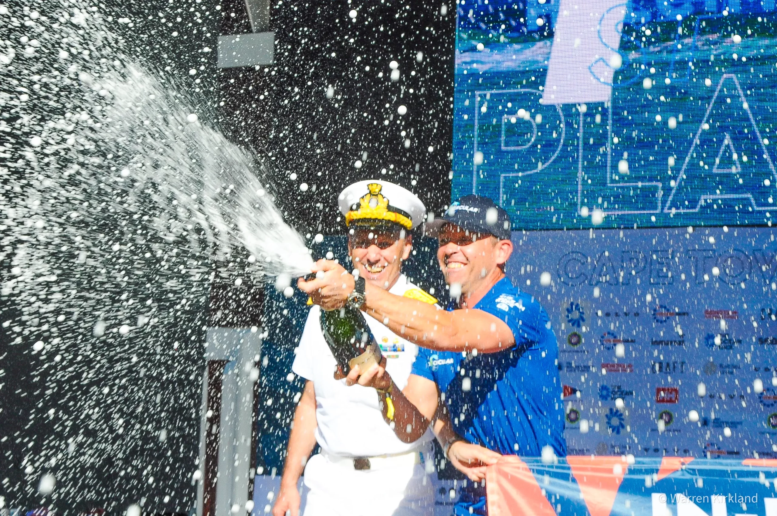 Sailors celebrating with champagne spray, The Ocean Race