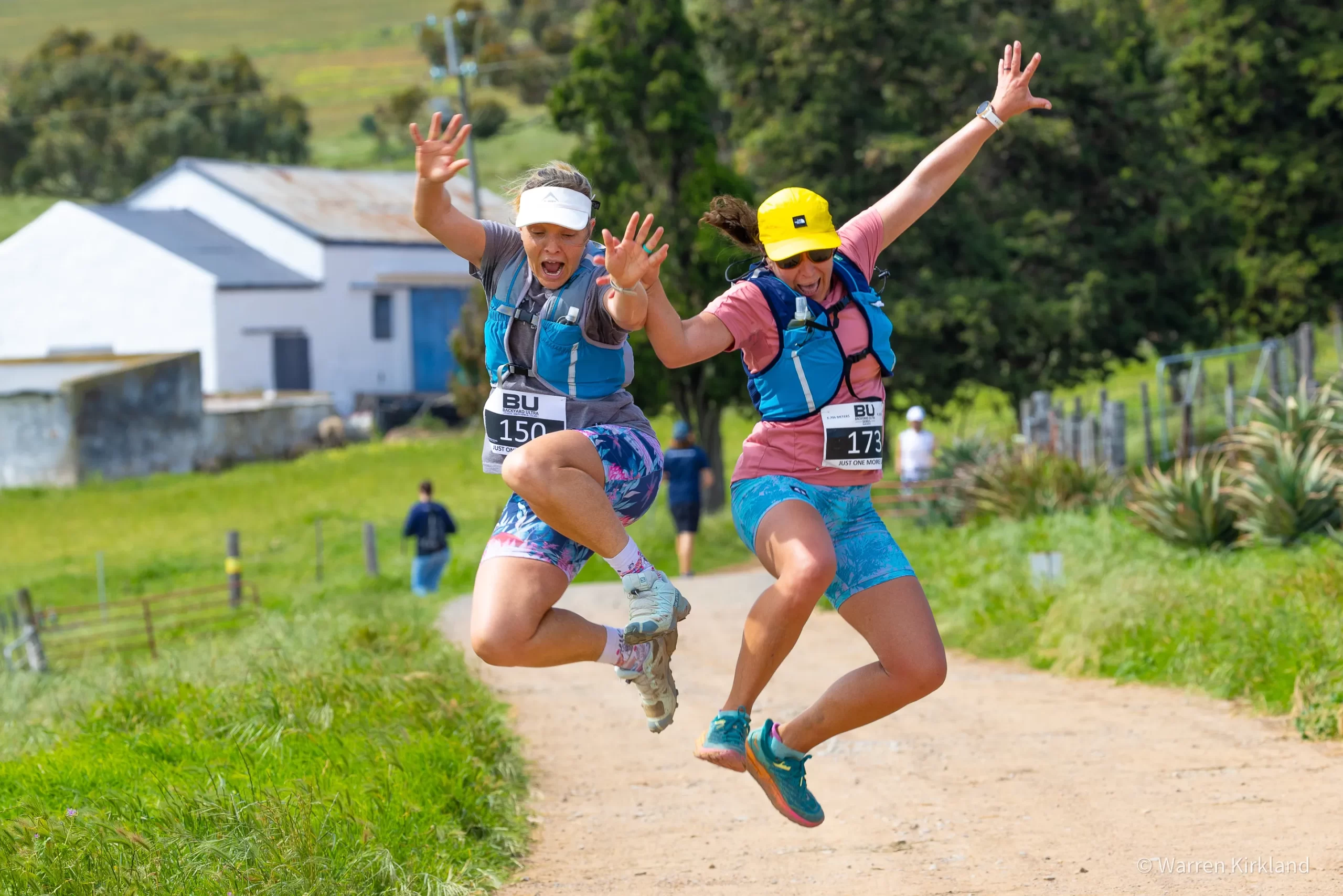 Two runners jumping joyfully mid-air, Backyard Ultra Series