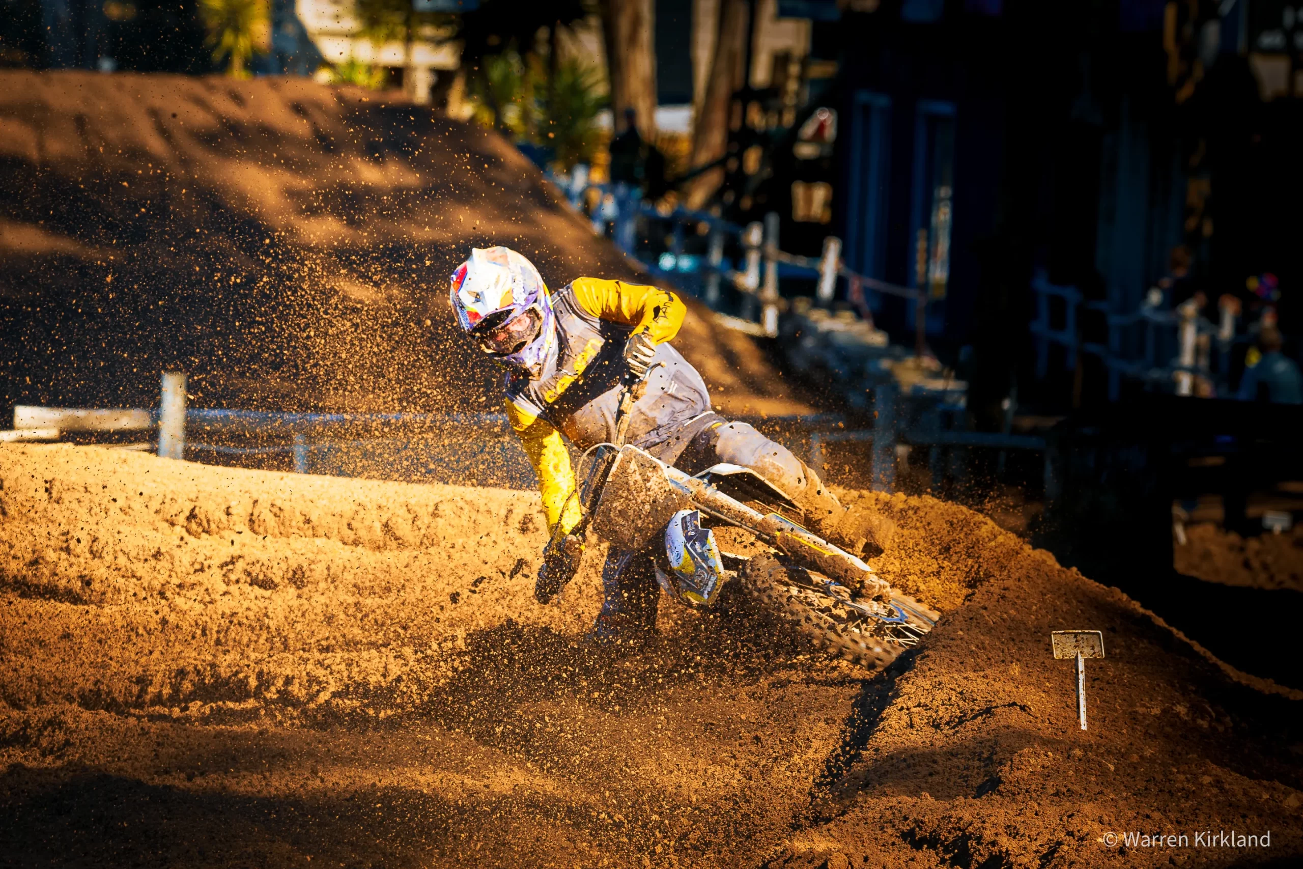 Motocross rider kicking up dirt through a corner, SA National Motocross