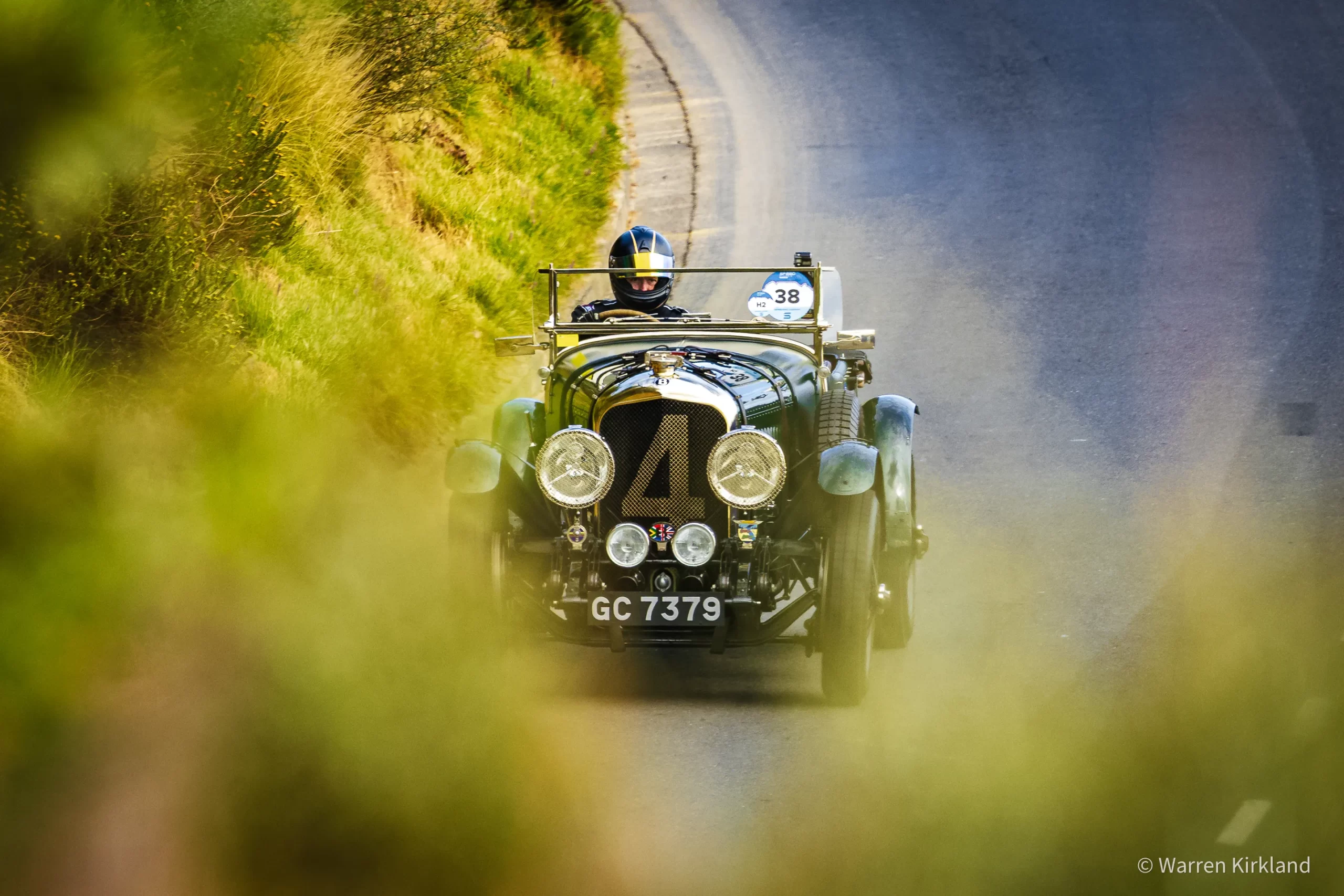 Vintage open-top racing car driving through mountain scenery, Speed Classic Cape Town