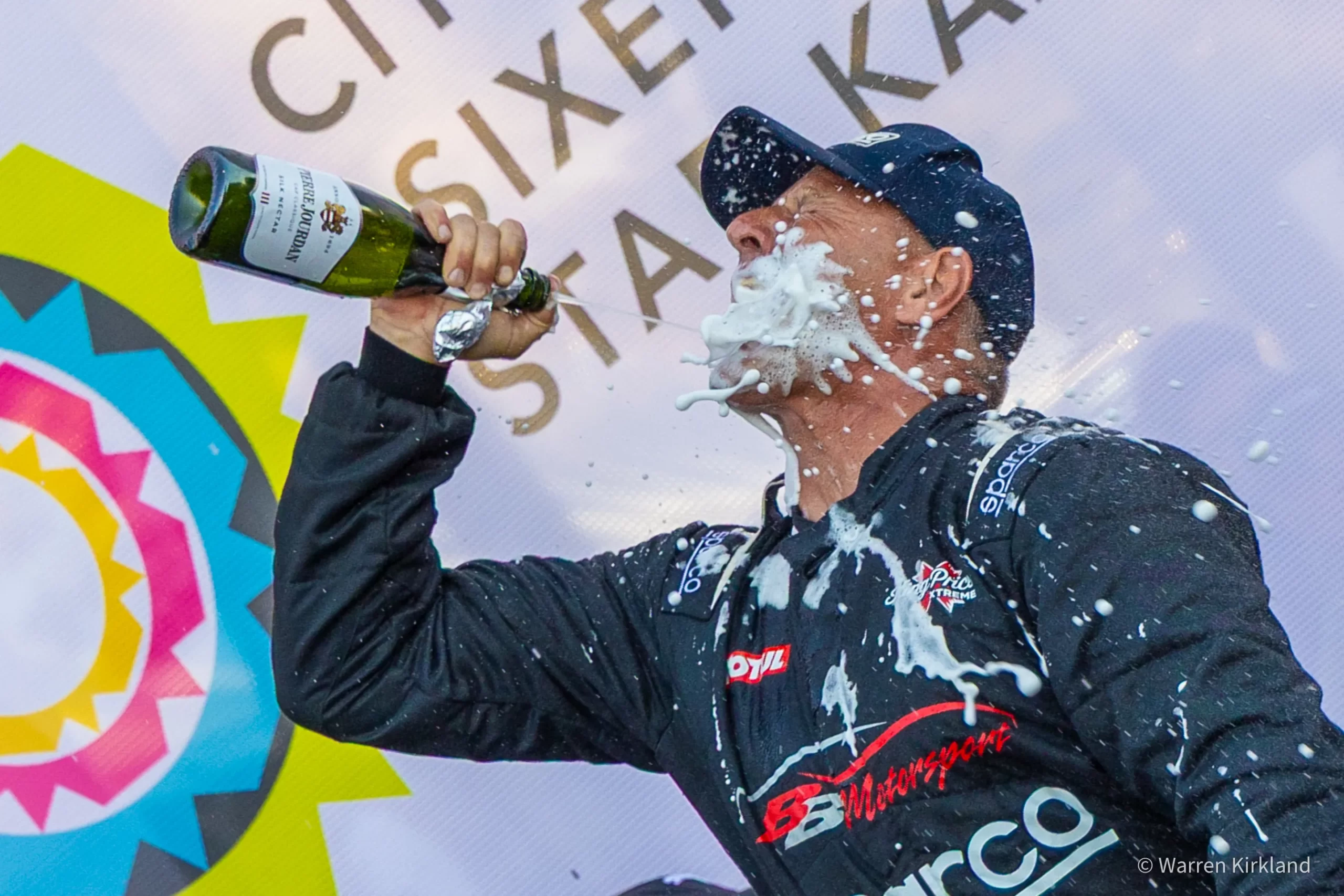 Podium winner spraying champagne over himself in celebration, Speed Classic Cape Town