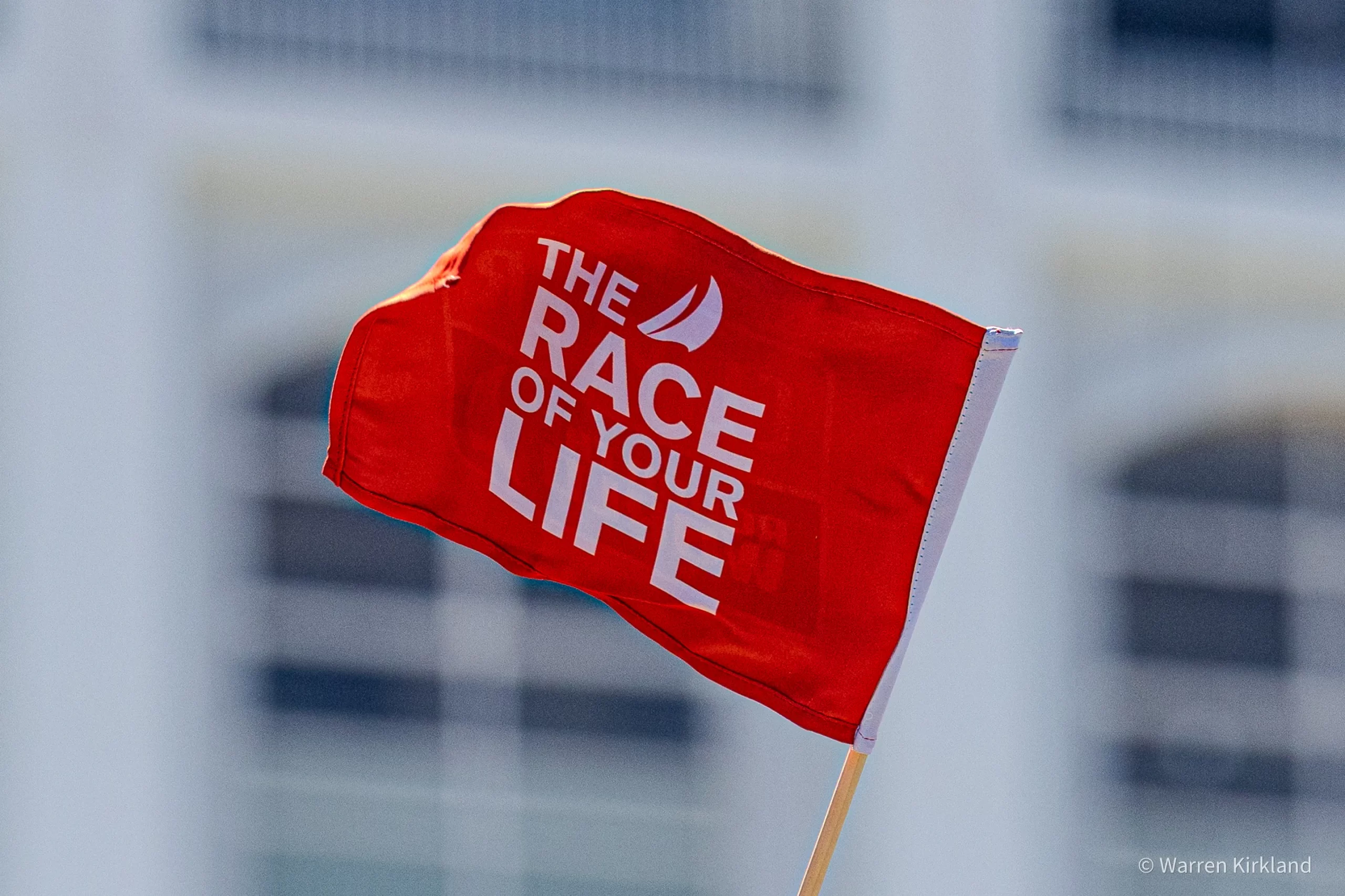 Red 'The Race of Your Life' flag waving, Clipper Round The World Race