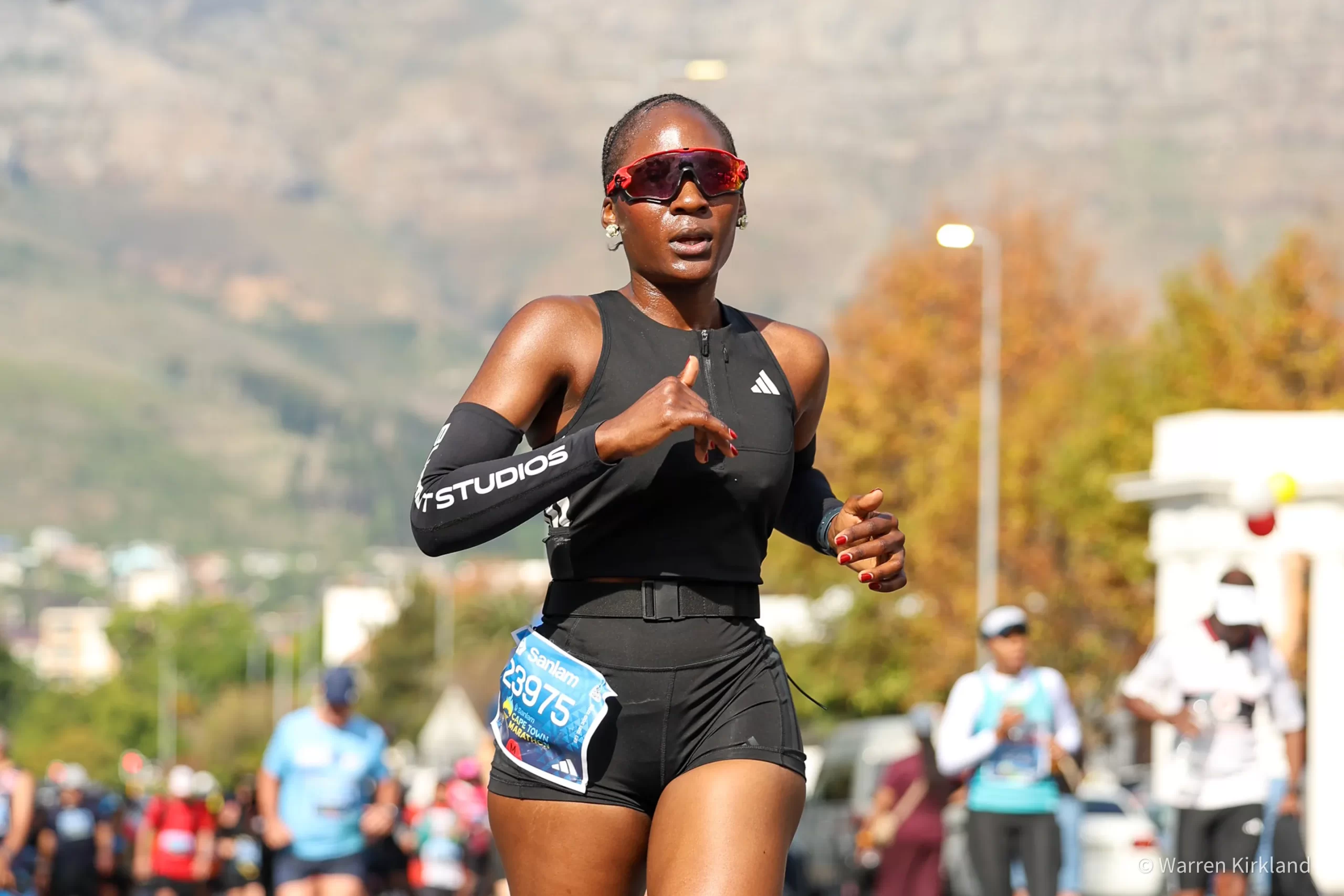 Runner mid-stride wearing sunglasses, Cape Town Marathon