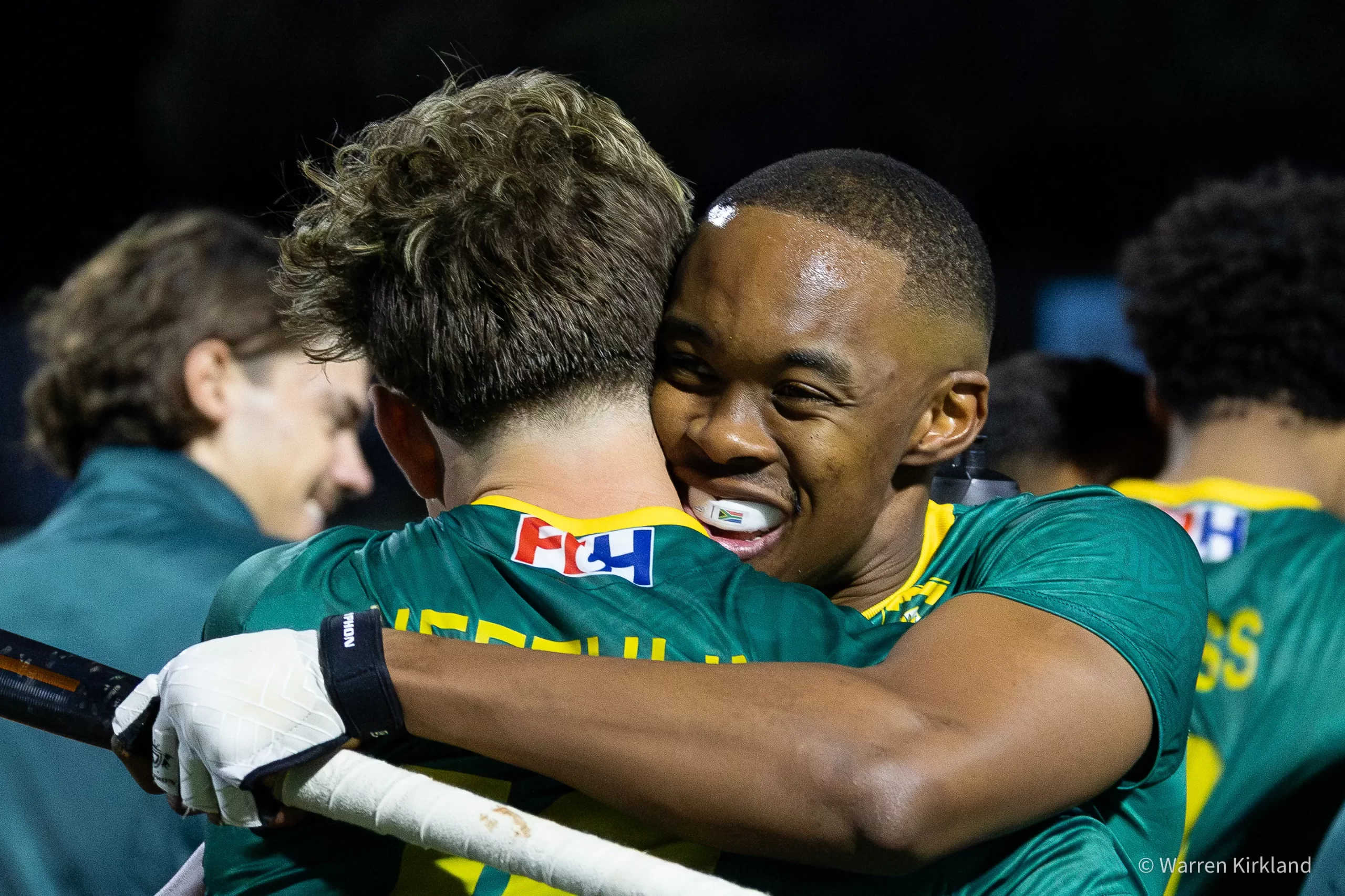 South Africa hockey teammates embracing after a goal, FIH Hockey Men's Nations Cup