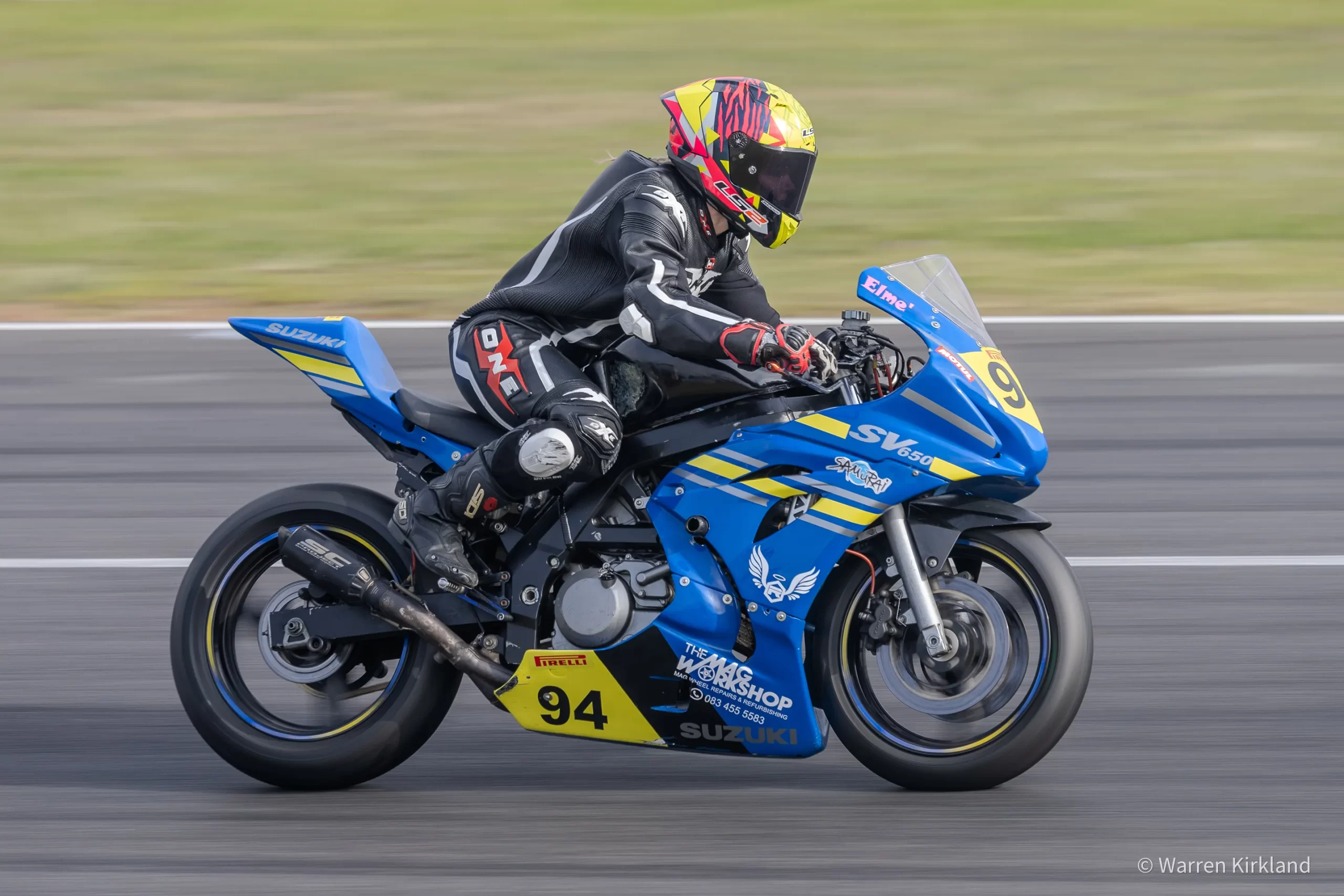 Suzuki motorcycle racer riding at speed, Power Series