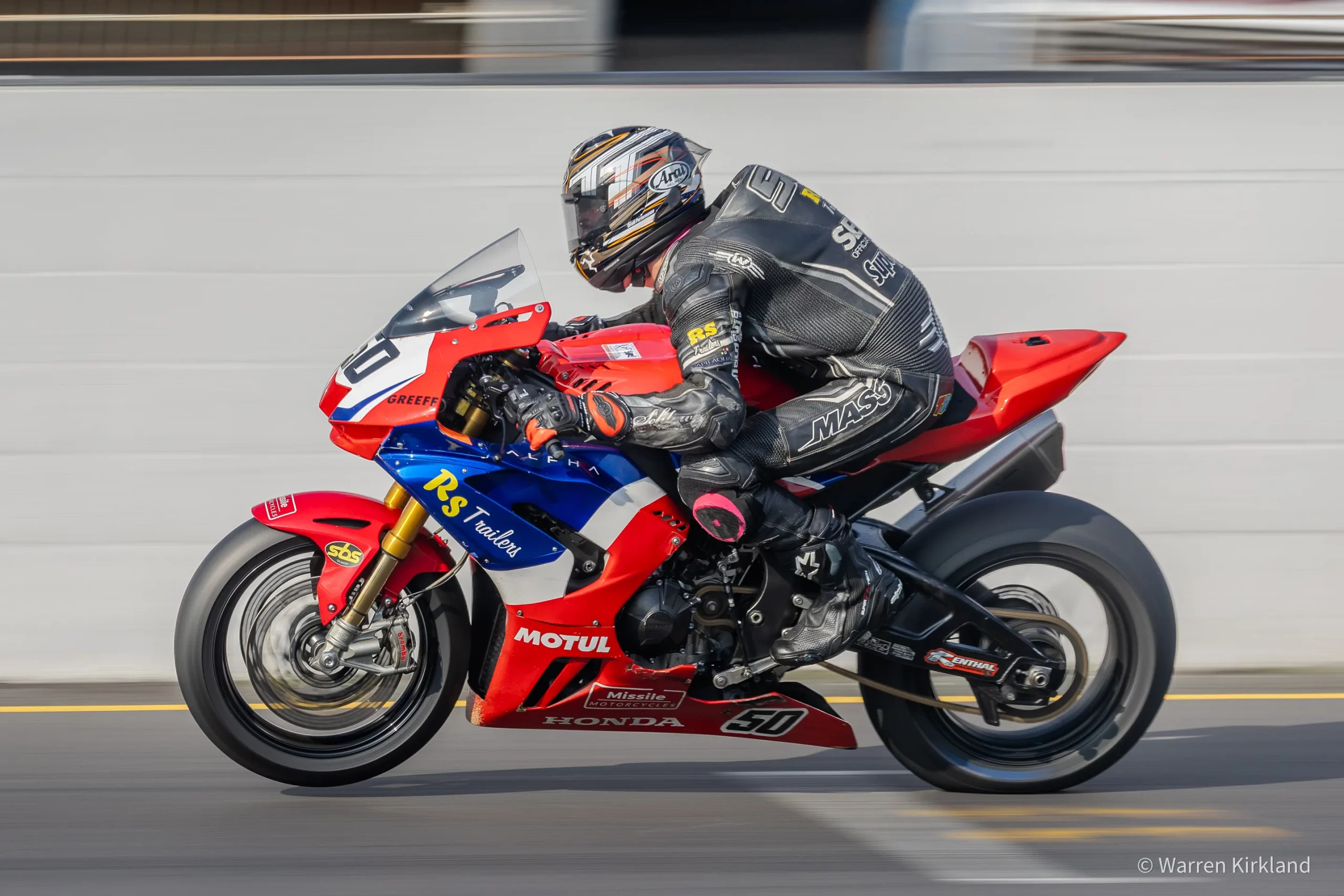 Superbike racer leaning into a corner, Power Series