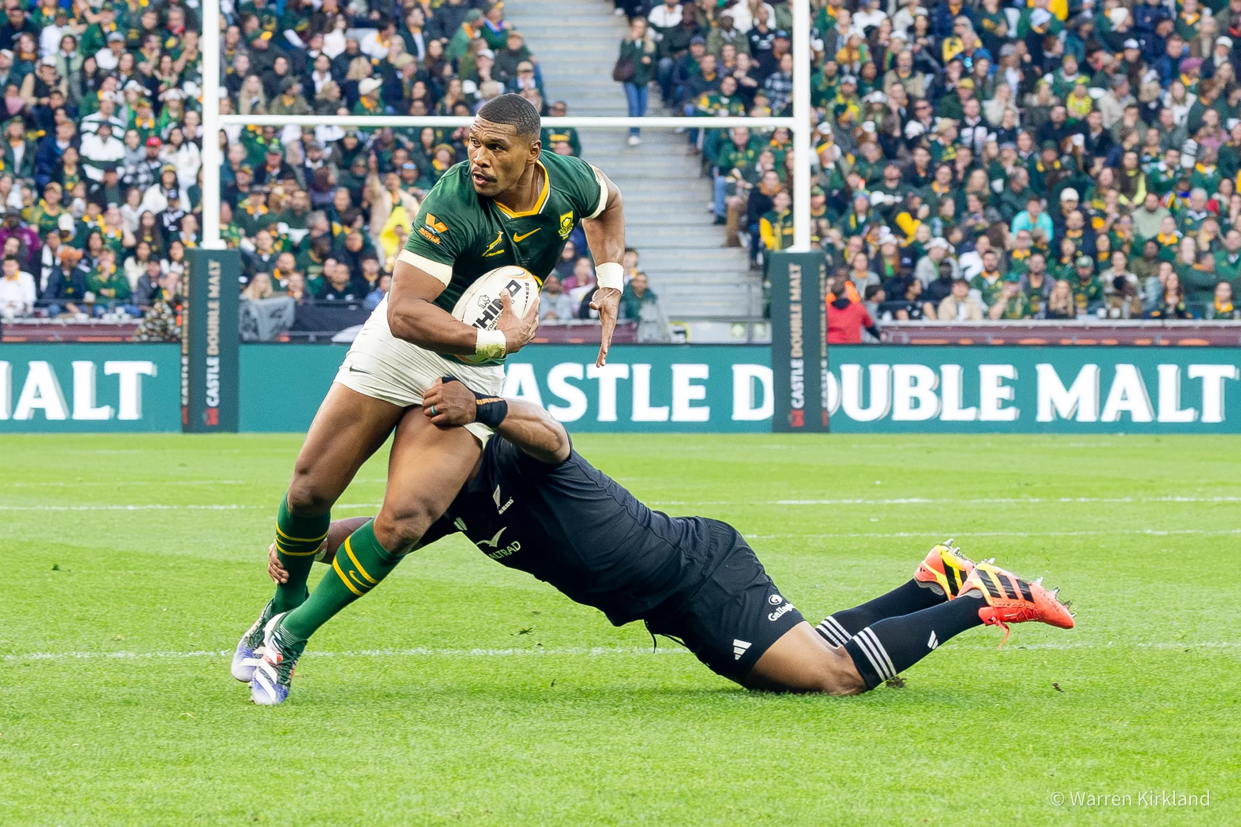 Cape Town sports and event photographer capturing a Springboks player being tackled with the ball by an All Blacks player, Rugby's Greatest Rivalry Tour - Springboks vs All Blacks